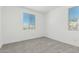 Bright bedroom features plush carpeting, neutral paint, and generous natural light from two windows at 4505 S Mole --, Mesa, AZ 85212