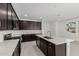 A modern kitchen features a large island, stainless steel appliances, and dark brown cabinets at 4505 S Mole --, Mesa, AZ 85212