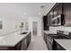 Modern kitchen features stainless steel appliances, a spacious island, and dark cabinetry at 4505 S Mole --, Mesa, AZ 85212