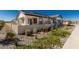 A rear view of the home featuring a covered patio, neutral color palette, and low-maintenance desert landscaping at 4505 S Mole --, Mesa, AZ 85212