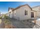 A side view of the home featuring gray siding, neutral color palette, and low-maintenance desert landscaping at 4505 S Mole --, Mesa, AZ 85212