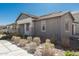 A side view of the home featuring gray siding, neutral color palette, and low-maintenance desert landscaping at 4505 S Mole --, Mesa, AZ 85212