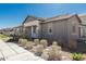 A side view of the home featuring gray siding, neutral color palette, and low-maintenance desert landscaping at 4505 S Mole --, Mesa, AZ 85212
