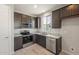 Modern kitchen featuring dark wood cabinets and granite countertops at 1291 W Treasure Trl, Apache Junction, AZ 85120