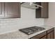 Gas cooktop and granite countertops in a modern kitchen at 1291 W Treasure Trl, Apache Junction, AZ 85120