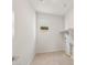 Laundry room with overhead shelving and window at 1449 W Saddle Run, Apache Junction, AZ 85120