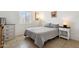 Cozy bedroom featuring a comfortable bed with neutral bedding, side tables and shuttered window at 15601 N 27Th St # 7, Phoenix, AZ 85032