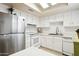 Bright kitchen featuring white cabinets, stainless steel refrigerator, and a skylight at 15601 N 27Th St # 7, Phoenix, AZ 85032