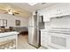 Kitchen featuring white appliances and cabinets, tile flooring, and stainless steel refrigerator at 15601 N 27Th St # 7, Phoenix, AZ 85032