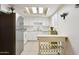 Bright kitchen featuring white cabinets, stainless steel refrigerator, and a skylight at 15601 N 27Th St # 7, Phoenix, AZ 85032