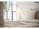 Neutral-toned bedroom with soft linens and bedside lamp at 312 E Windsor Ave # 11, Phoenix, AZ 85004