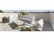 Stylish rooftop patio featuring modern white seating arrangements and potted plants at 312 E Windsor Ave # 11, Phoenix, AZ 85004