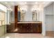 Bathroom featuring a double vanity with granite countertop, dark wood cabinets, and glass enclosed shower at 41313 N Rolling Green Way, Anthem, AZ 85086