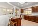 Kitchen featuring an island with seating and an open view to the dining and living room at 41313 N Rolling Green Way, Anthem, AZ 85086