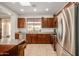 Well-lit kitchen with stainless steel appliances and wood cabinets, plus a skylight above at 41313 N Rolling Green Way, Anthem, AZ 85086