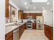 Modern kitchen featuring stainless steel appliances and wood cabinets with tile floor at 41313 N Rolling Green Way, Anthem, AZ 85086