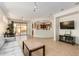 Bright and airy living room leading to the dining area and kitchen with tile floors at 41313 N Rolling Green Way, Anthem, AZ 85086