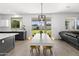 Bright dining area with white table and yellow chairs, adjacent to kitchen at 4503 E Decatur St, Mesa, AZ 85205