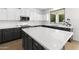 Modern kitchen with white and dark gray cabinets and expansive quartz countertops at 4503 E Decatur St, Mesa, AZ 85205