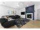 Living room with fireplace, built-ins, and a cozy sectional sofa at 4503 E Decatur St, Mesa, AZ 85205