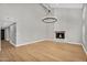 Cozy living room featuring wood floors, a fireplace, and neutral paint throughout at 12222 N 74Th St, Scottsdale, AZ 85260