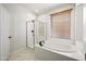 Bathroom with soaking tub, shower, and marble tile floor at 41432 N Bent Creek Way, Phoenix, AZ 85086