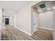 Long hallway with wood-look floors and neutral walls at 41432 N Bent Creek Way, Phoenix, AZ 85086