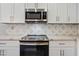 Modern range and microwave in white kitchen at 41432 N Bent Creek Way, Phoenix, AZ 85086