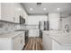 Modern kitchen with white cabinets and geometric backsplash at 41432 N Bent Creek Way, Phoenix, AZ 85086