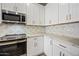 White kitchen with modern cabinetry and quartz countertops at 41432 N Bent Creek Way, Phoenix, AZ 85086