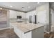 Kitchen island with white cabinets and a large quartz countertop at 41432 N Bent Creek Way, Phoenix, AZ 85086