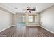 Bright living room with wood-look floors, sliding door to backyard, and ceiling fan at 41432 N Bent Creek Way, Phoenix, AZ 85086