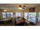 Inviting dining room with a modern ceiling fan, large windows, and a spacious table for gatherings at 17200 W Bell Rd # 569, Surprise, AZ 85374