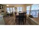 Bright dining room featuring a wood dining table, chairs, and lots of natural light from the large windows at 17200 W Bell Rd # 569, Surprise, AZ 85374
