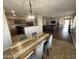 Farmhouse dining table with gray chairs, adjacent to kitchen at 1244 E Desert Rose Trl, San Tan Valley, AZ 85143