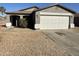 One-story house with a two-car garage and desert landscaping at 1244 E Desert Rose Trl, San Tan Valley, AZ 85143