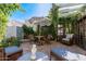 Charming backyard patio with lush greenery, comfortable seating, and an inviting umbrella shade at 8101 N Central Ave # 6, Phoenix, AZ 85020