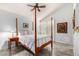 Cozy bedroom with a four poster bed, ceiling fan, and shuttered windows at 8101 N Central Ave # 6, Phoenix, AZ 85020