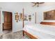 Bright primary bedroom with wood floors, a four-poster bed, and ensuite bathroom access at 8101 N Central Ave # 6, Phoenix, AZ 85020