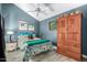 Comfortable bedroom with a ceiling fan, and a decorative wooden wardrobe, offering a cozy retreat at 8101 N Central Ave # 6, Phoenix, AZ 85020