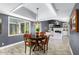 Bright dining space with wood table, pendant lighting, and views into living area at 8101 N Central Ave # 6, Phoenix, AZ 85020