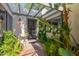 Home's entryway has brick pathway and lush landscaping by a wood-framed doorway at 8101 N Central Ave # 6, Phoenix, AZ 85020