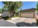 Attached home's two-car garage is front-facing and features mature landscaping on a sunny day at 8101 N Central Ave # 6, Phoenix, AZ 85020