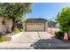 Attached two-car garage with decorative door stands beside a tennis court on a sunny day at 8101 N Central Ave # 6, Phoenix, AZ 85020