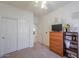 Bedroom featuring a closet, neutral carpet, TV, and wooden dresser at 29922 N Little Leaf Dr, San Tan Valley, AZ 85143