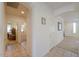 Hallway with tile flooring leading to doorways and multiple rooms at 29922 N Little Leaf Dr, San Tan Valley, AZ 85143