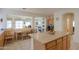 Open-concept kitchen island with views to the breakfast nook, living room, and office space at 29922 N Little Leaf Dr, San Tan Valley, AZ 85143
