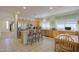 Well-lit kitchen with stainless steel appliances, a breakfast bar, and an adjacent dining area at 29922 N Little Leaf Dr, San Tan Valley, AZ 85143