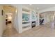 Open-concept living area featuring built-in shelves, a fireplace, and tile flooring at 29922 N Little Leaf Dr, San Tan Valley, AZ 85143