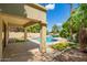 Backyard paradise features lush landscaping, pool, and a serene canal at 3327 S Felix Way, Chandler, AZ 85248